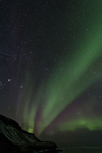Low angle view of aurora borealis at night