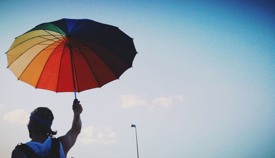 Low angle view of person holding umbrella
