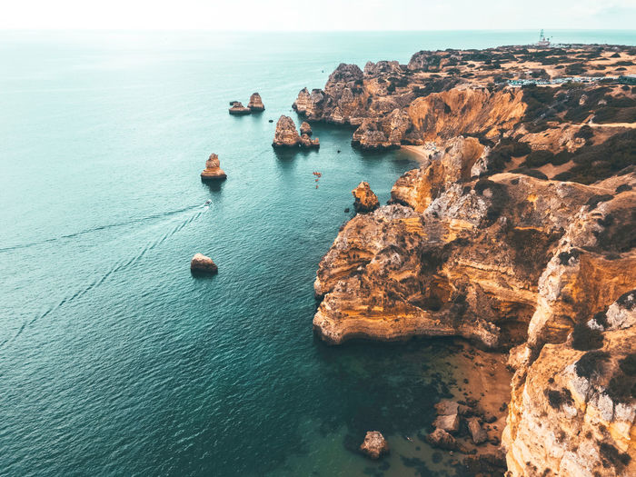 Ocean landscape with rocks and cliffs at lagos bay coast in algarve, portugal
