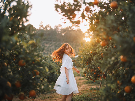 Woman standing against trees