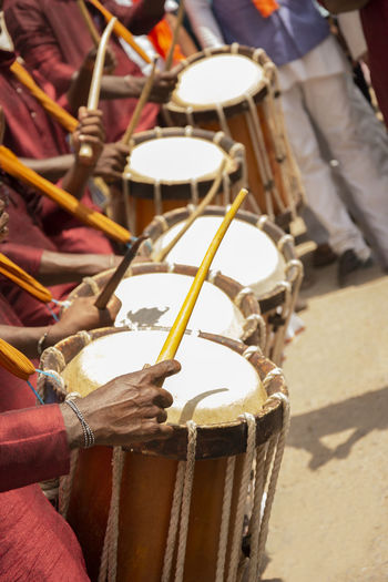 Close-up of men playing drums