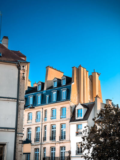 Low angle view of building against clear blue sky