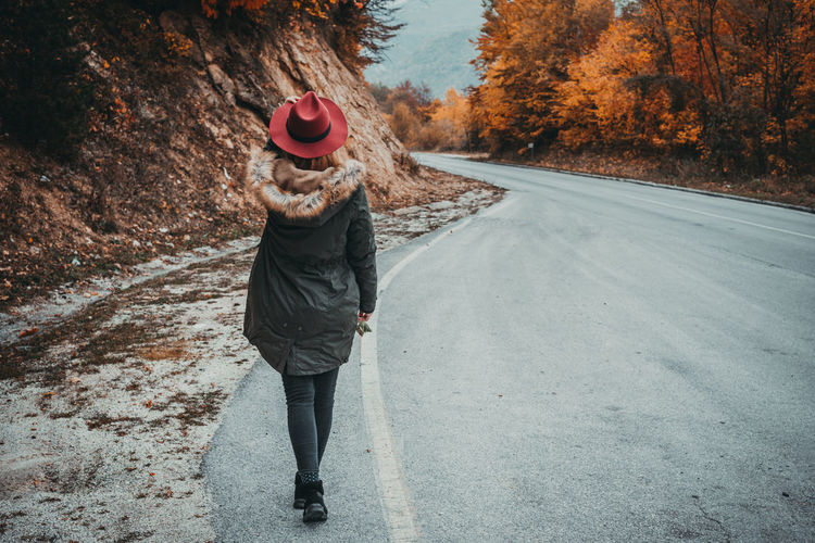 Woman with hat exploring the autumn mountain