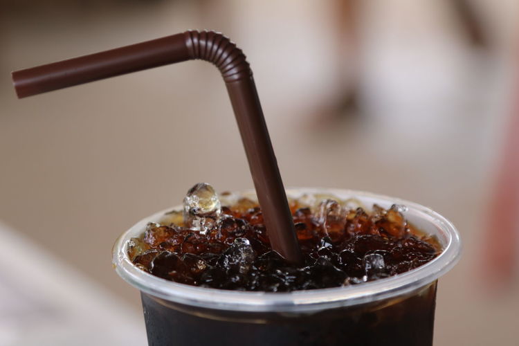Close-up of drinking straw in ice slush