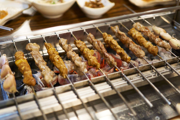 Close-up of meat skewers on barbecue grill