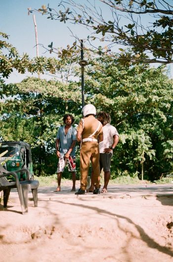 Rear view of people walking on street