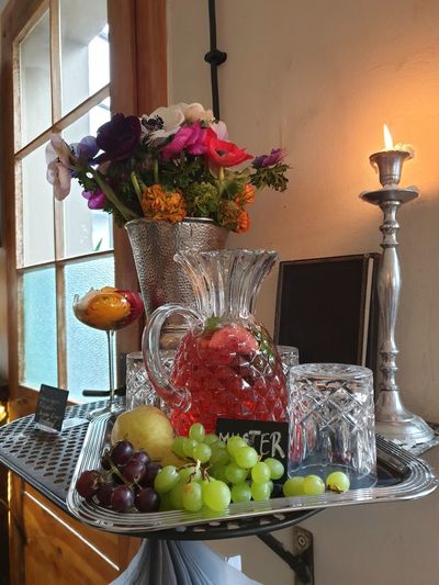 Flowers in glass vase on table at home