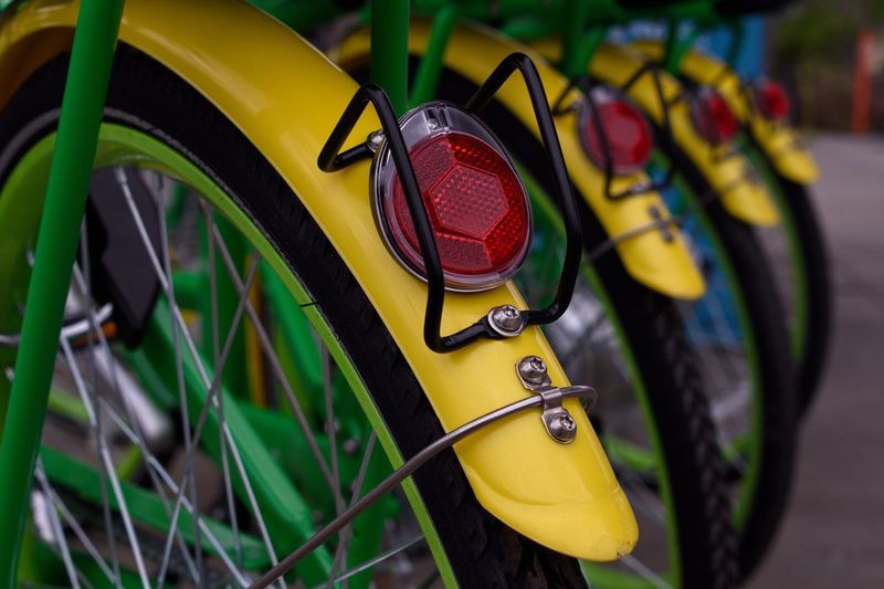 Close-up of yellow bicycle wheel