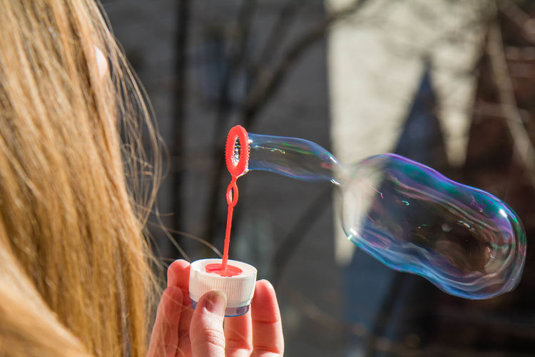 View of woman holding bubble wand