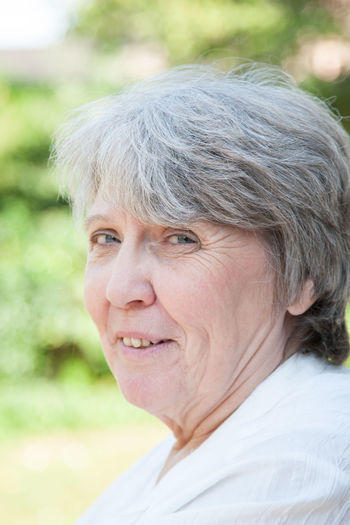 Portrait of smiling senior woman at park