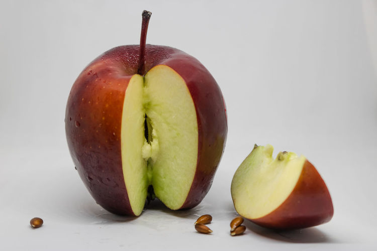 Close-up of apple on table against white background