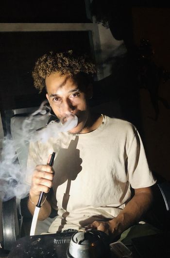 Young man smoking hookah