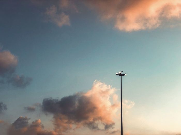 Low angle view of floodlight against sky
