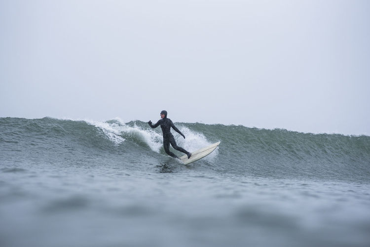 Woman surfing during winter snow