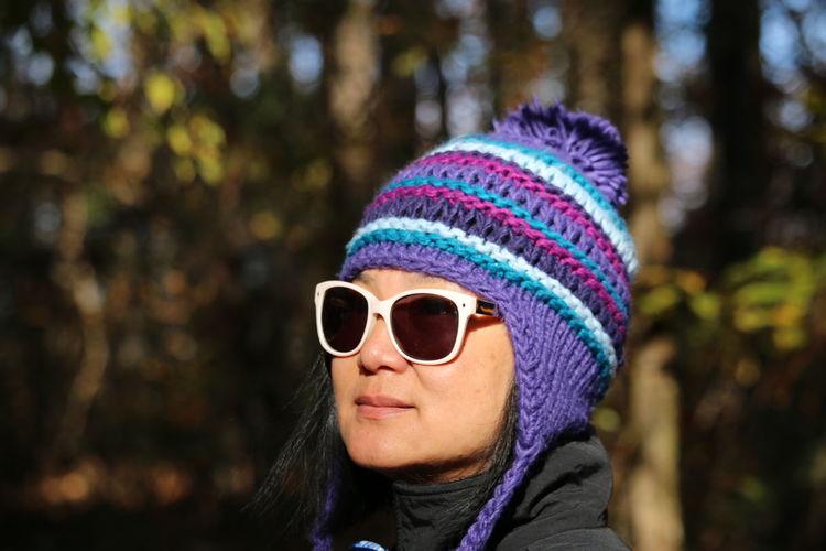Close-up of woman wearing sunglasses and knit hat