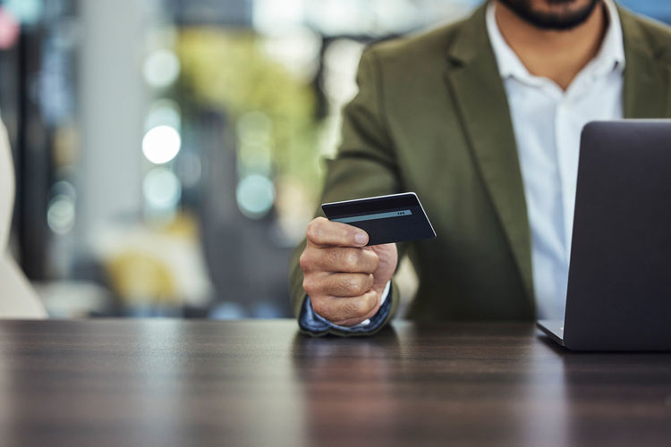 Midsection of businessman using mobile phone