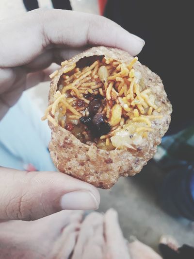 Cropped hand holding panipuri