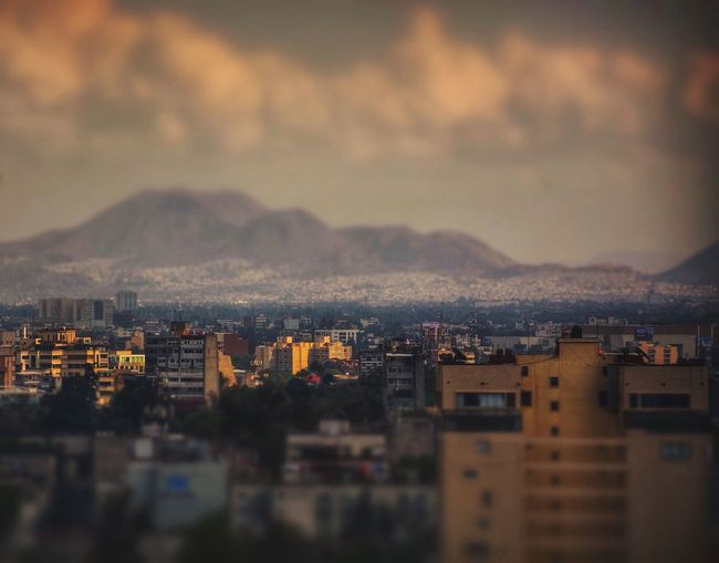 Cityscape against cloudy sky