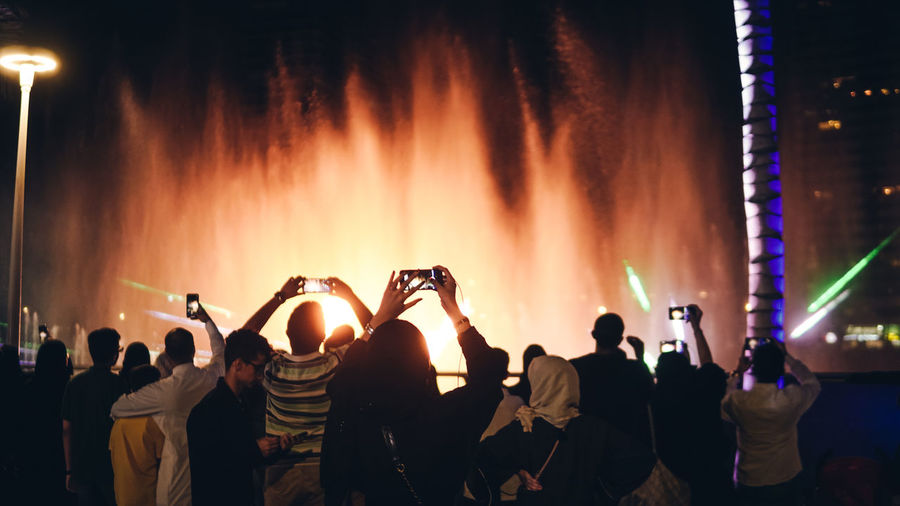 People enjoying music concert at night during jeddah season