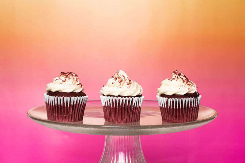 Close-up of cupcakes against pink background