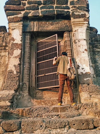 Full length of man standing against old temple 