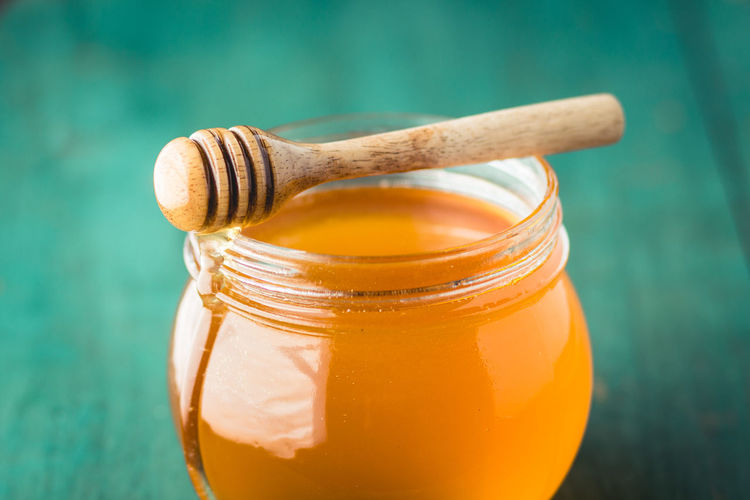 Close-up of honey with dipper on table