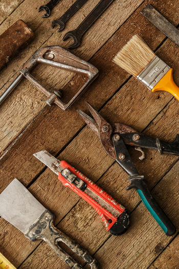 High angle view of work tools on wooden table