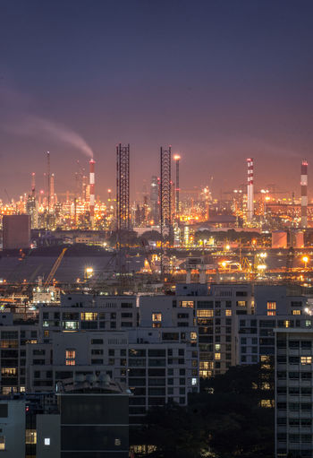 Illuminated oil refineries and petrochemical plants at night