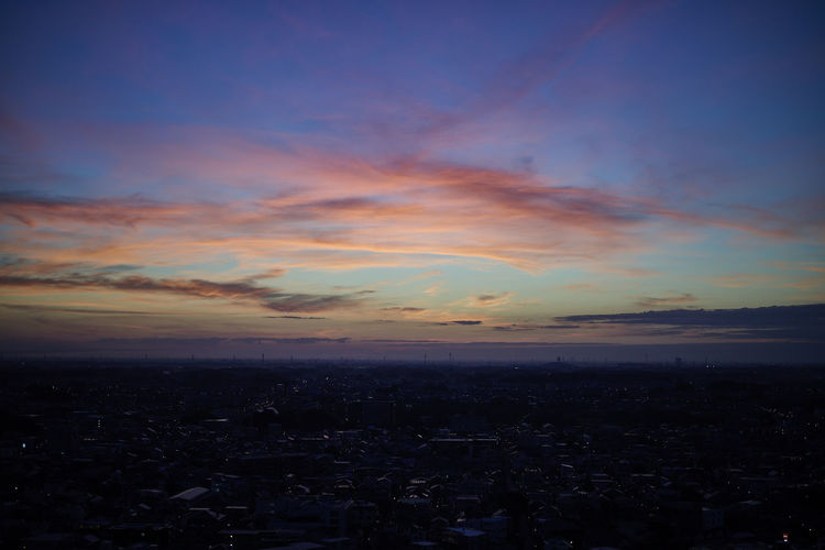 Aerial view of cityscape against sky during sunset