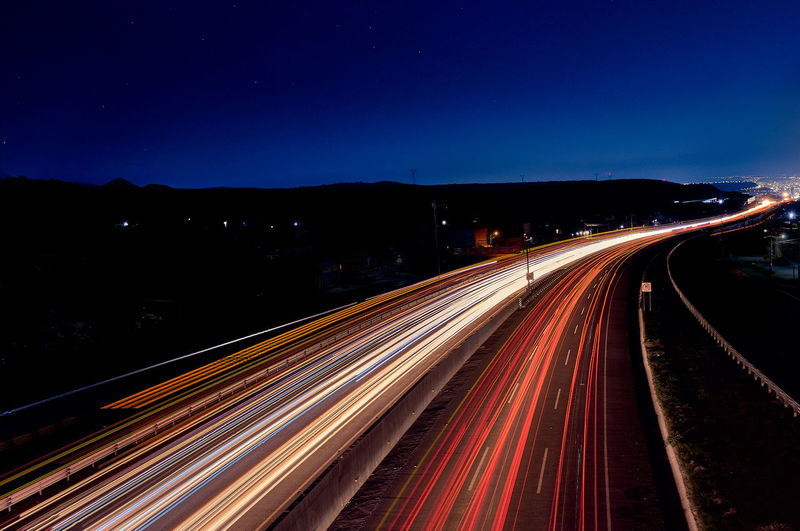 High angle view of light trails on road at night