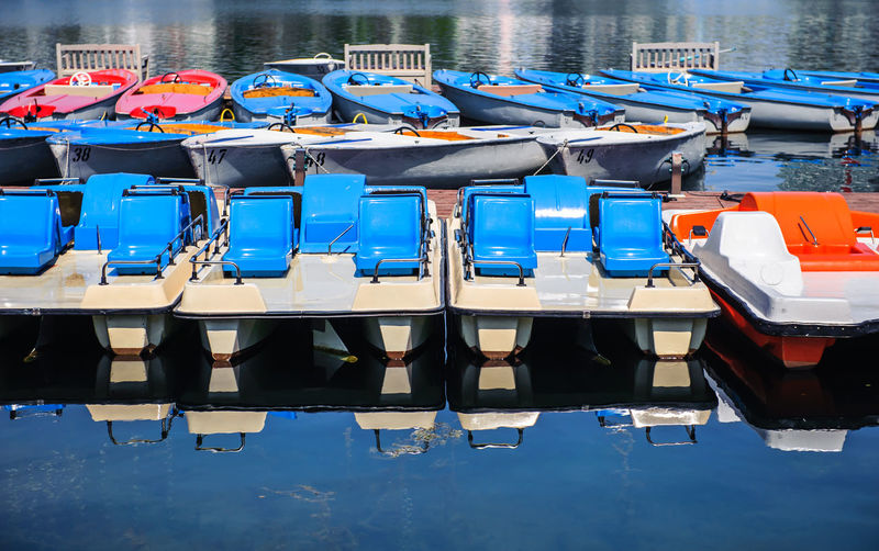 Row of boats moored in water