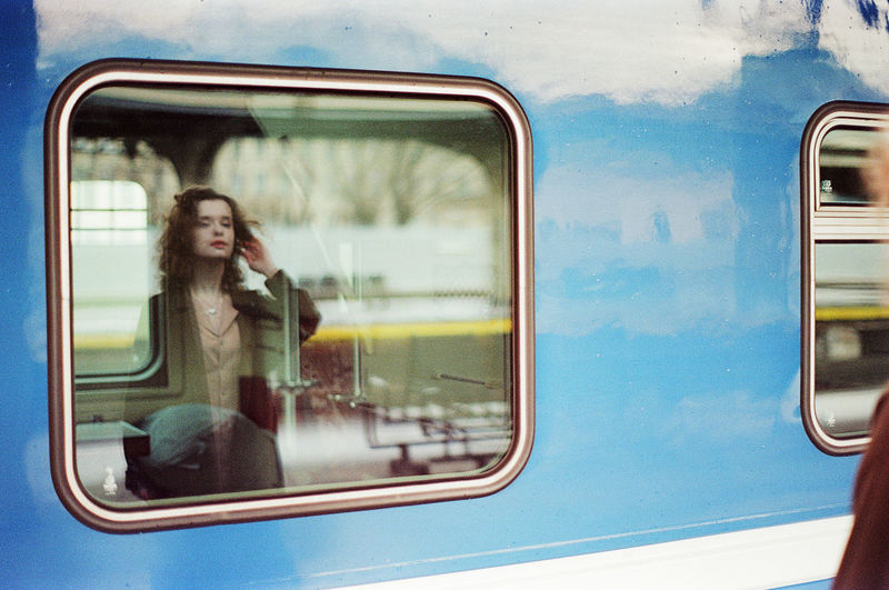 Reflection of woman on train window