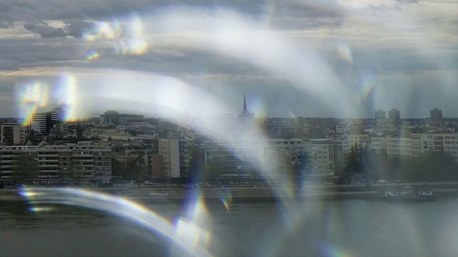 Digital composite image of buildings against sky in city