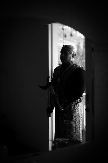 Man standing at doorway in darkroom