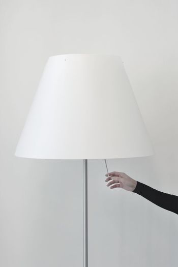 Close-up of hand turning on lamp