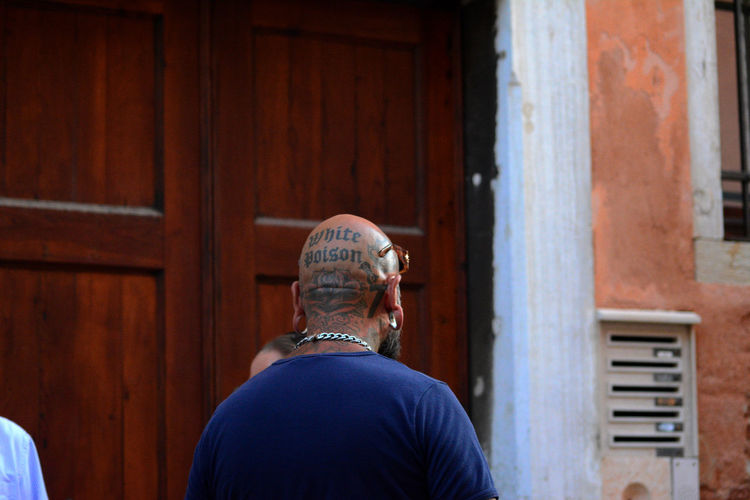 Rear view of a tattooed man walking in venice
