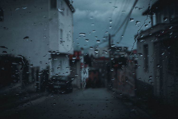 Full frame shot of wet glass window in rainy season