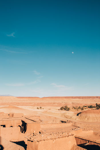 Scenic view of desert against blue sky