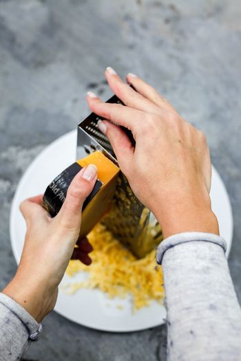 Close-up of woman grating the cheese