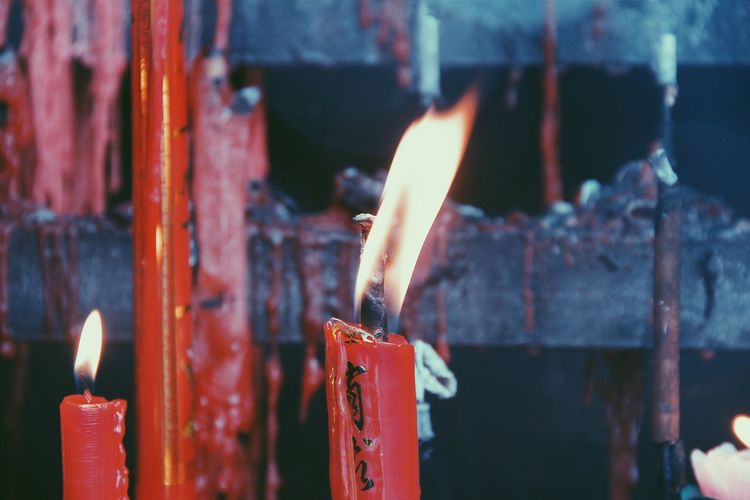 Close-up of burning candles at temple