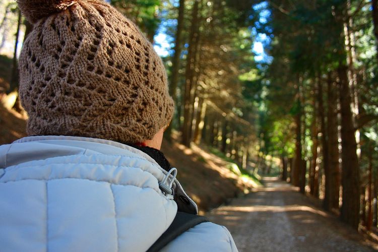 Close-up of woman on dirt road in forest