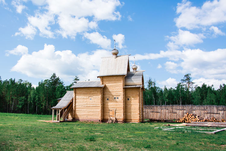 An old wooden orthodox church in a russian village on a summer day