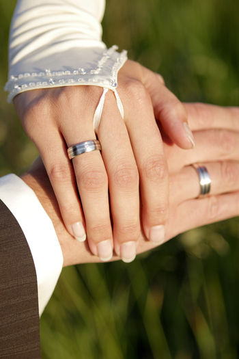 Cropped hands of couple showing wedding rings