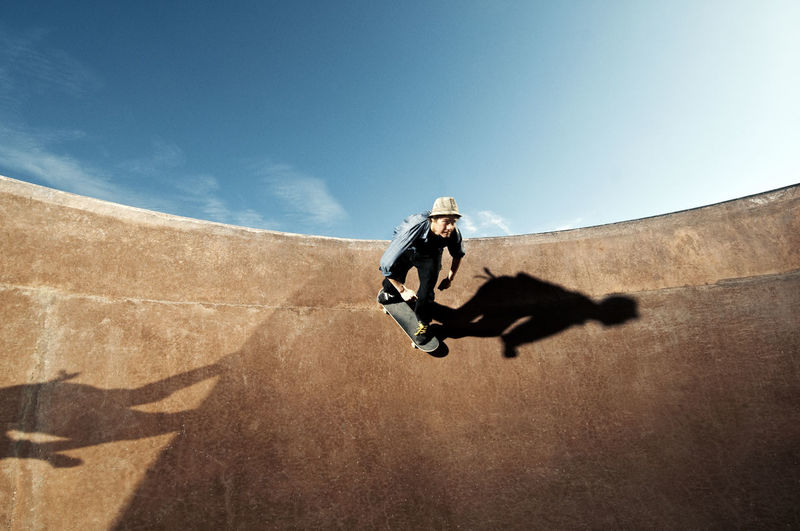 Low angle view of man skateboarding on skate ramp against sky