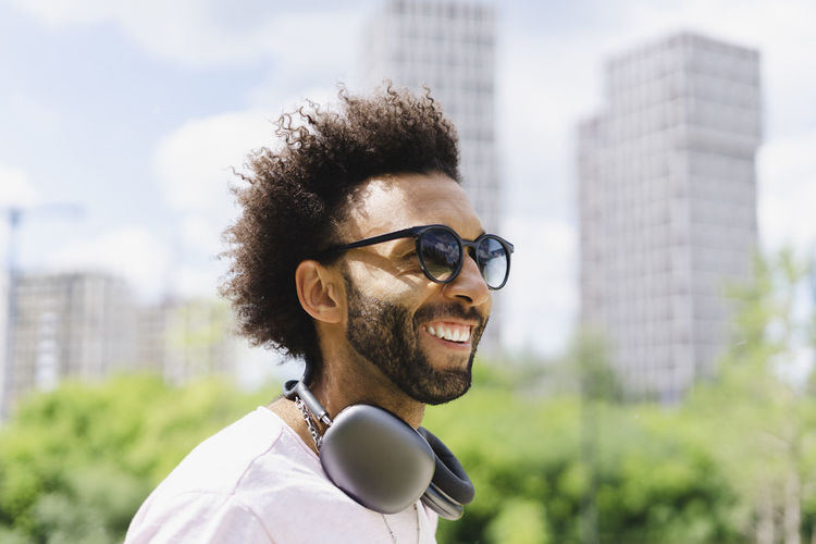 Happy man with headphones wearing sunglasses