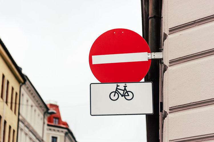 No entry sign for vehicular traffic except bicycles. road sign against old europe cityscape.