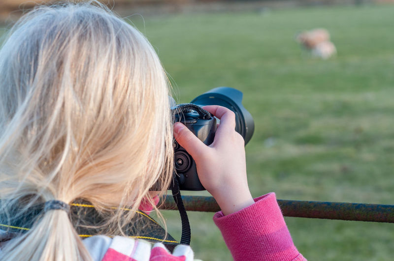 Rear view of woman photographing