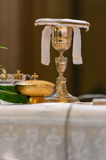 The elevation of the goblet with the sacramental wine during the catholic liturgy of the eucharist