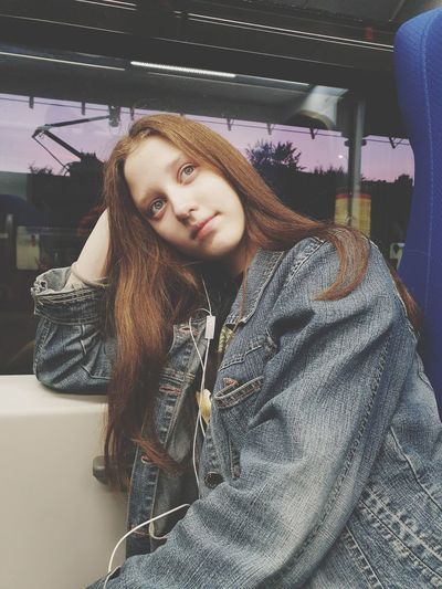 Portrait of beautiful young woman in train