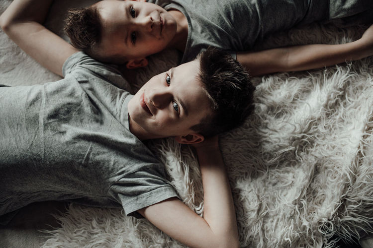 Portrait of young couple lying on bed
